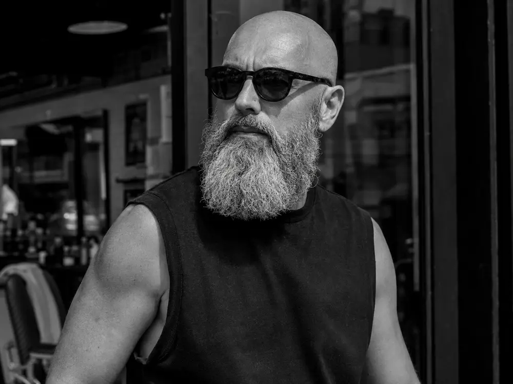 Stylish bald man with a long beard
