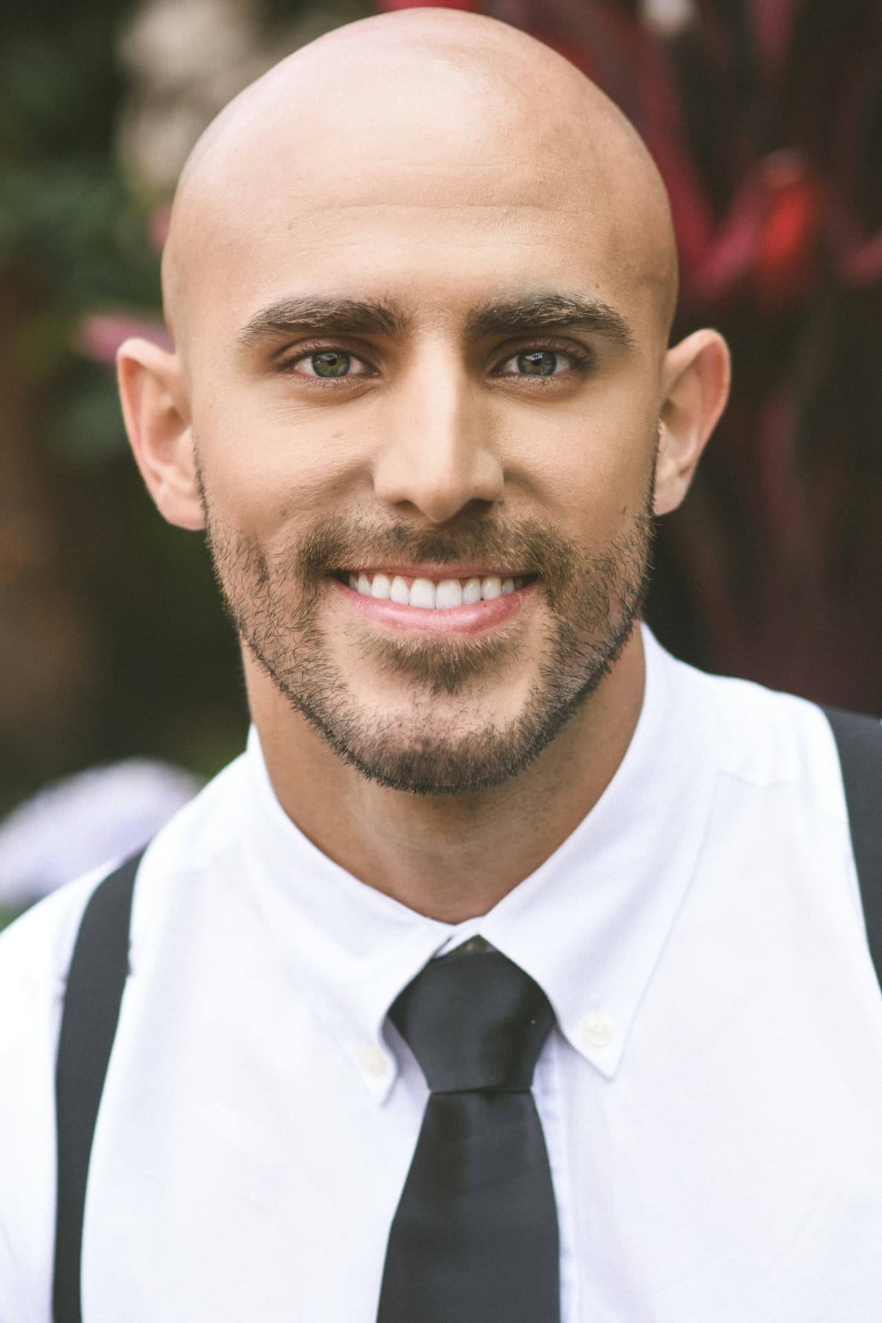 Bald man with neatly groomed facial hair looking ahead